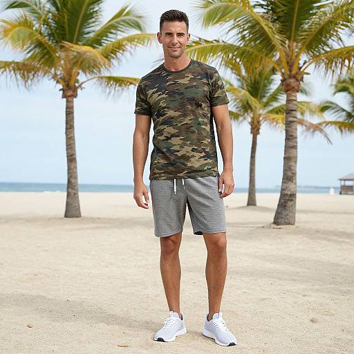 Man Wearing Camouflage T-Shirt and Gray Shorts on Beach with Palm Trees