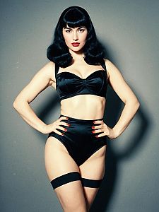 Woman in Bettie Page Bangs Hairstyle and Black Lingerie Pin-Up Costume Full Body Photo