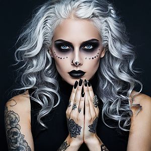Striking Woman with Silver Hair and Gothic Makeup
