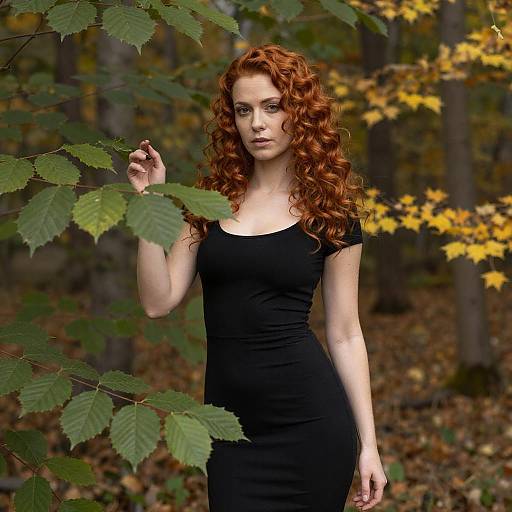 Red Haired Woman in Black Dress Amidst Autumn Leaves