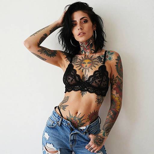 Edgy Tattooed Woman in Black Lace Bralette and Distressed Jeans
