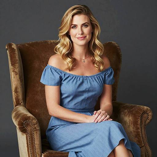 Blonde Woman in Off-Shoulder Blue Dress Sitting in Vintage Armchair
