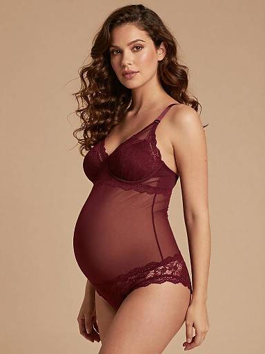 Pregnant Woman in Burgundy Lace Maternity Bodysuit