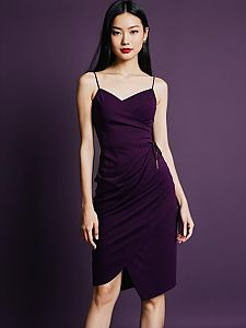 Elegant Woman in Purple Wrap Dress on Purple Background