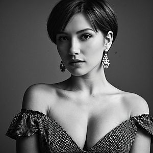 Black and white portrait of a young woman in an off-the-shoulder dress
