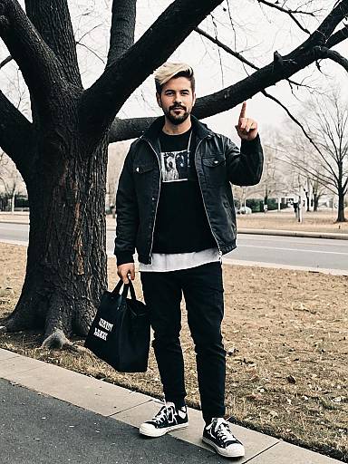 Young Man in Casual Streetwear Outfit Standing by Tree Carrying Tote Bag