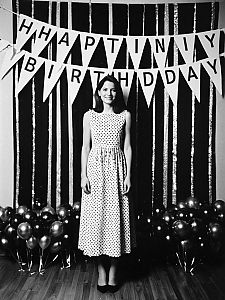 Woman in Polka Dot Dress at Vintage Birthday Party Decoration