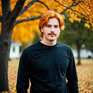 Portrait of Red-Haired Man in Autumn Park with Fall Foliage
