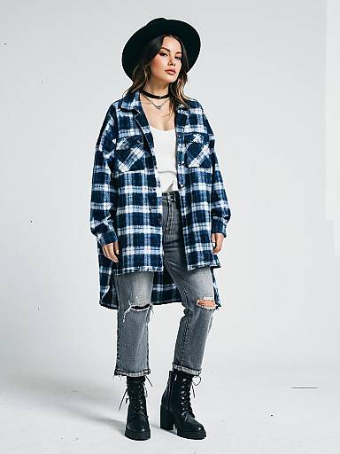 Woman in Casual Streetwear Oversized Blue Plaid Shacket and Ripped Jeans