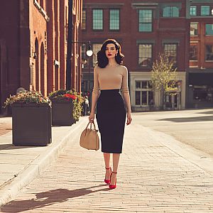 Fashionable Woman in Beige and Black on City Sidewalk