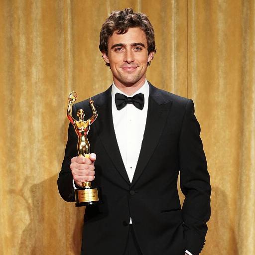 Young Man Holding Gold Award at Formal Ceremony in Tuxedo