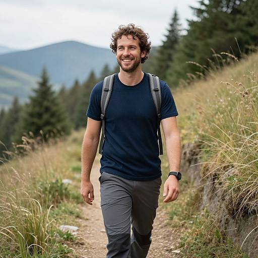 Smiling Man Hiking on Mountain Trail with Backpack