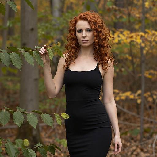 Young Woman with Curly Red Hair in Black Dress Autumn Forest Portrait