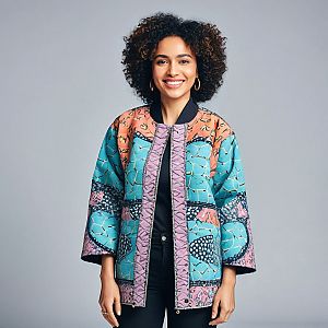 Smiling Woman in Colorful Patterned Jacket