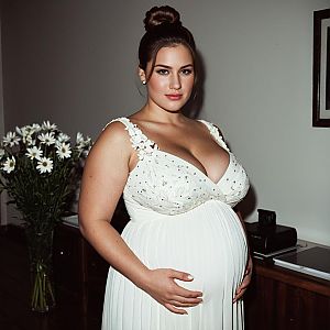 Plus Size Pregnant Woman in Elegant White Evening Gown