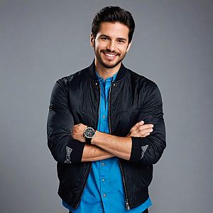 Smiling man in blue shirt and black bomber jacket