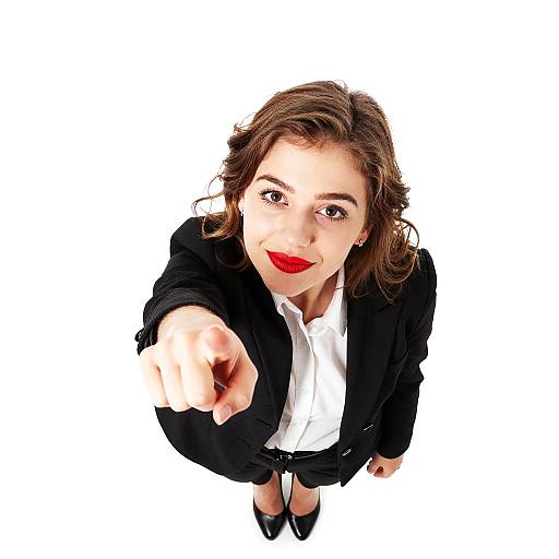 Confident Professional Woman Pointing at Camera in Black Suit