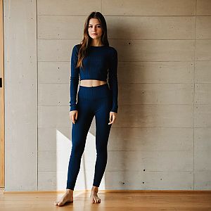 Woman in Navy Blue Ribbed Set Against Concrete Wall