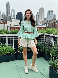 Young Woman in Mint Green Peplum Blouse and Scalloped Shorts on Urban Rooftop