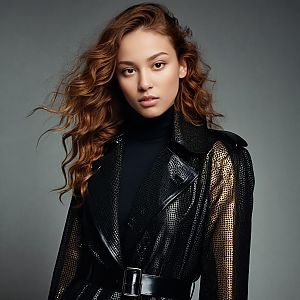 Fashion Portrait of Woman in Black and Gold Textured Jacket with Wavy Hair