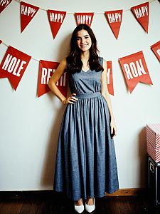 Woman Celebrating Birthday in Stylish Gray Dress with Festive Decorations