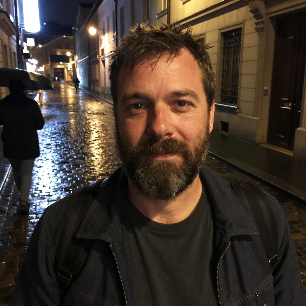 Bearded Man on Rainy Night Urban Street