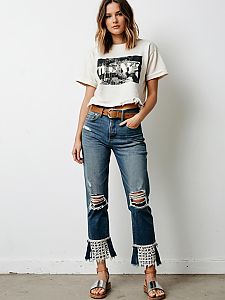 Stylish Woman in Distressed Cropped T-Shirt and Ripped Lace-Trim Jeans