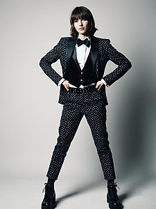 Man in Stylish Femboy Costume with Polka Dot Suit and Velvet Vest