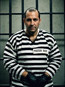 Man in Prison Costume with 'Photon Man' Label in Photorealistic Studio Portrait