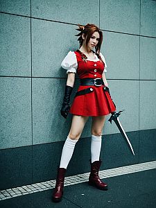 Woman in Aerith Cosplay Costume Holding Sword Full Body Photo