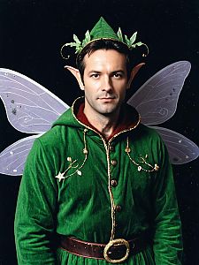 Photorealistic Man in Green Fairy Costume with Pointed Ears and Purple Wings Studio Portrait
