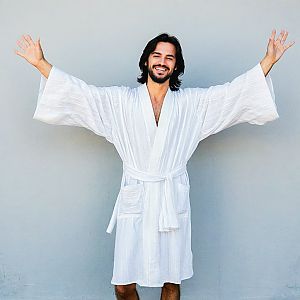 Happy man in bathrobe with joyful expression