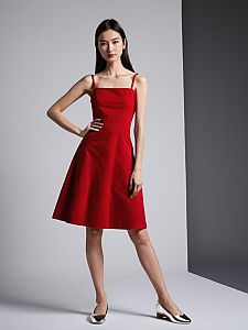 Stylish Woman in Red A-Line Dress Posing in Minimalist Studio