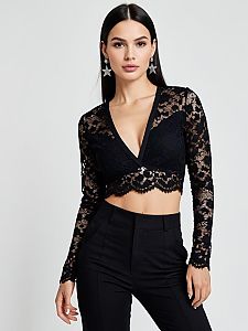 Woman in Contemporary Chic Black Lace Crop Top with Plunging Neckline and Long Sleeves