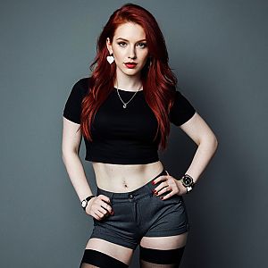 Confident Woman with Red Hair in Edgy Fashion