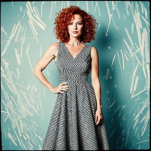 Elegant Woman in Vintage Black-and-White Checkered Dress with Curly Red Hair