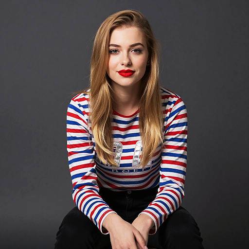 Young Woman with Red Lipstick and Striped Shirt Sitting Pose