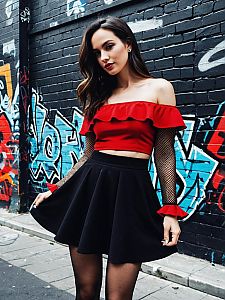 Fashionable Woman in Red Crop Top and Black Skirt Posing by Graffiti Wall