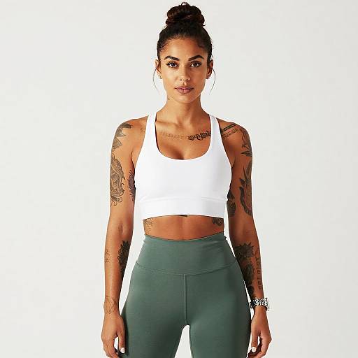 Tattooed Woman in White Sports Bra and Green Leggings Fitness Portrait