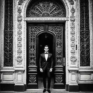 Elegant Man in Tuxedo at Ornate Doorway