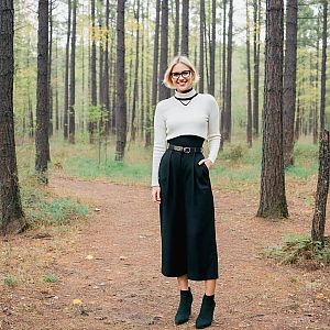 Stylish woman in forest path with modern outfit