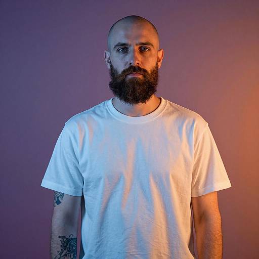 Portrait of Bearded Bald Man in White T-Shirt with Tattoos and Dual-Tone Lighting