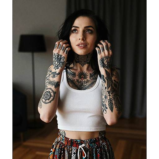 Tattooed Woman Wearing White Crop Top and Colorful Pants Indoor Portrait