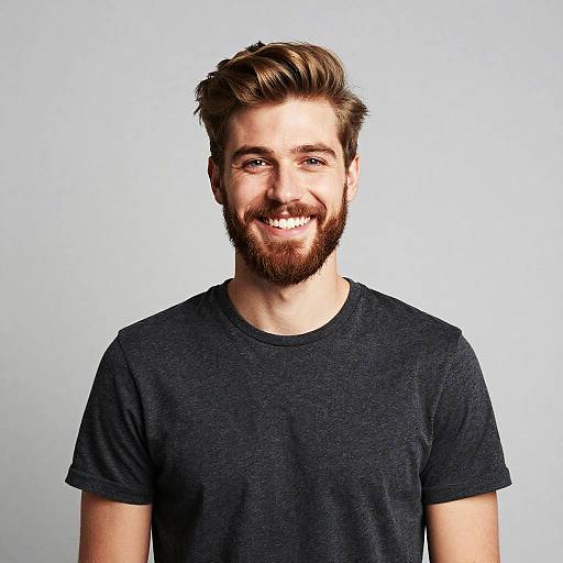 Portrait of Smiling Young Man with Beard Wearing Gray T-Shirt