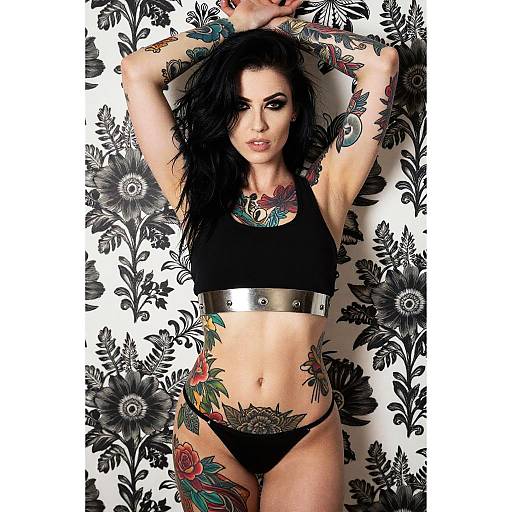 Tattooed Woman in Black Crop Top and Floral Background