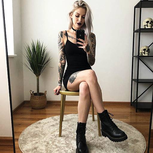 Tattooed Woman in Black Dress and Combat Boots Taking Selfie
