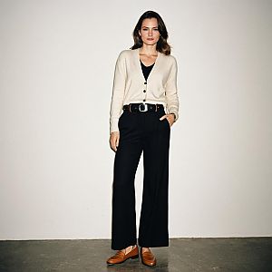 Stylish Woman in Minimalist Cream Cardigan and Black Wide-Leg Trousers
