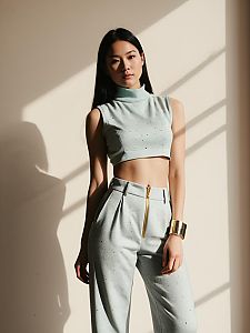 Woman in Modern Urban Sleeveless High Neck Crop Top with Metallic Specked Pants