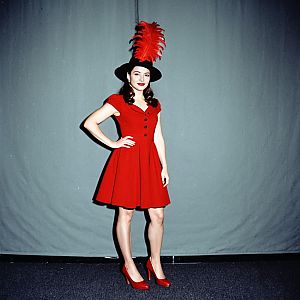 Woman in Red Dress with Black Hat and Feather