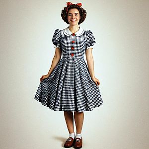 Smiling Woman in Vintage Checkered Dress with Red Bow